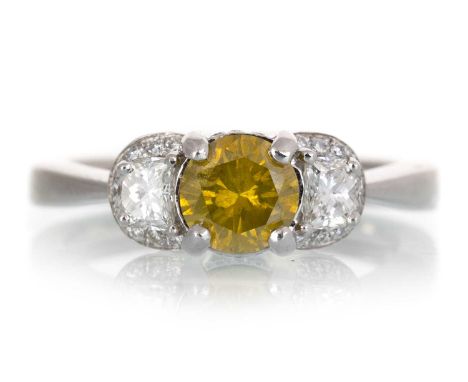 CERTIFICATED DIAMOND THREE STONE RING, set with a central treated yellow diamond of approximately 0.68 carats, flanked by two
