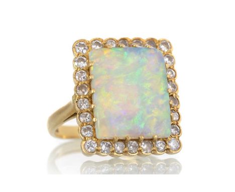 OPAL AND DIAMOND RING, set with a central opal slice bordered by round brilliant cut diamonds, in eighteen carat gold, size O