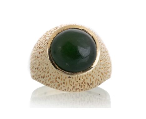 JADE DRESS RING, 1960s  with a central cabochon jade stone, in fourteen carat gold, size JQty: 6 grams gross
