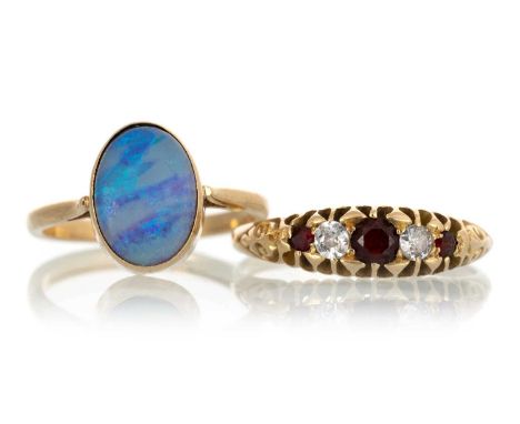 TWO DRESS RINGS, IN EIGHTEEN CARAT GOLD  one set with an oval opal, the other with garnets and diamondsQty: 6.4gOpal size NOt