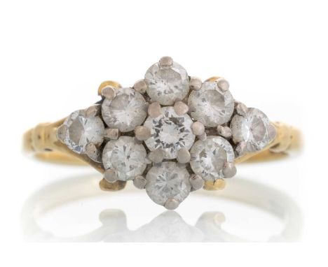 DIAMOND CLUSTER RING, IN EIGHTEEN CARAT GOLD set with nine round brilliant cut diamonds in a marquise formQty: 3.3g