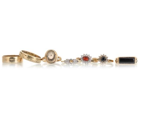 GROUP OF DRESS AND WEDDING RINGS, comprising four nine carat gold rings, a diamond set eighteen carat gold ring (centre stone