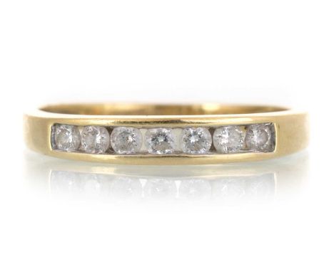 DIAMOND SEVEN STONE RING, with small channel set diamonds totalling approximately 0.25 carats, in eighteen carat gold, size O