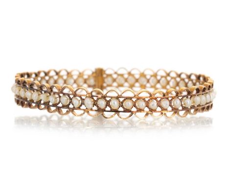 PEARL BANGLE, EARLY 20TH CENTURY  set with a row of seed pearls, unmarked Qty: 17.9g