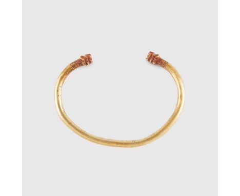 ANCIENT GREEK GOLD BANGLE EASTERN MEDITERRANEAN, 5TH - 4TH CENTURY B.C. solid gold bangle with lions head terminalsDimensions