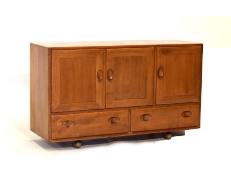 Ercol 'Golden Dawn' elm sideboard fitted three cupboard doors over two drawers on castors, 129cm wide  