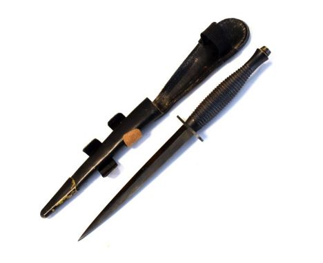 Fairburn Sykes type double edged fighting knife/dagger with ring grip, no markings present, within the original leather scabb