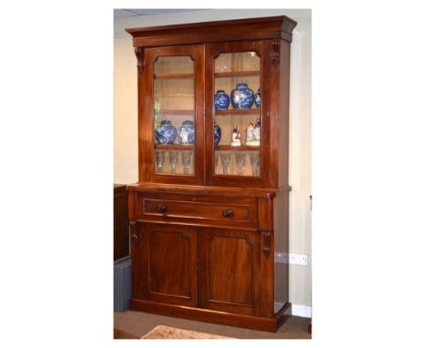 Victorian mahogany secretaire bookcase, the upper section having a cavetto-moulded cornice over glazed doors enclosing two ad