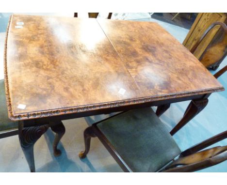 Burr walnut extending dining table with carved decorative edging with four matching upholstered dining chairs and a matching 
