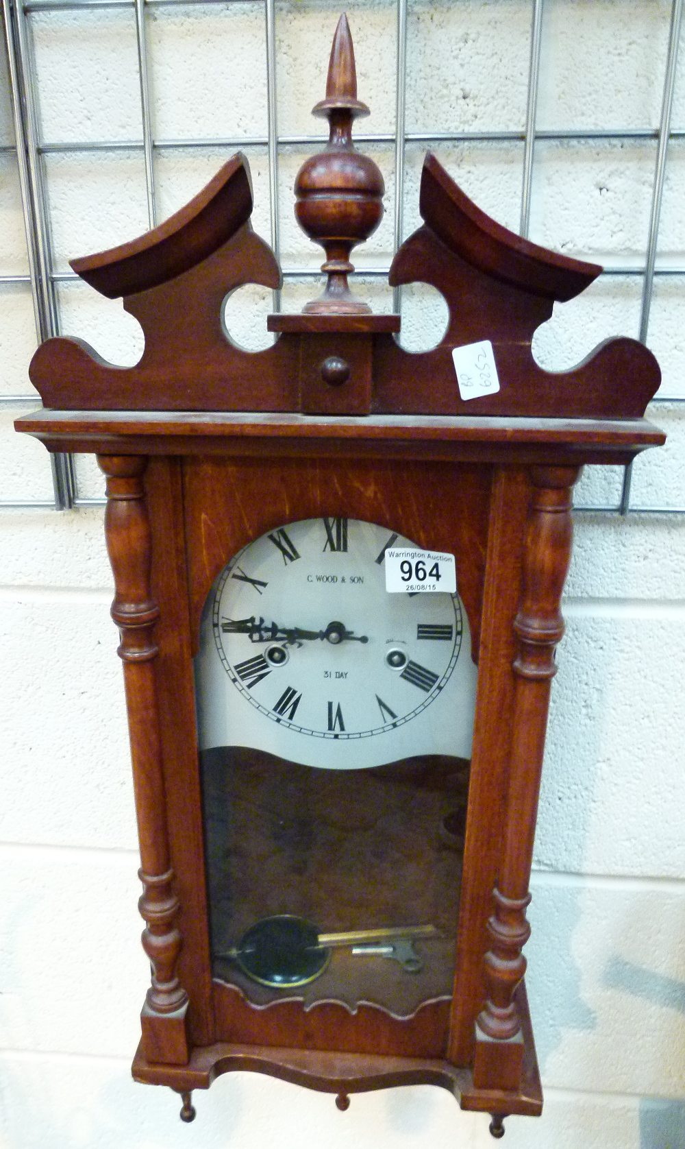 C Wood & Son wall hanging wood cased 31 day clock with key and pendulum