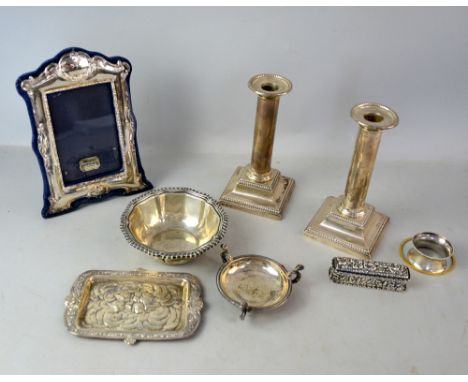 Group of silver items to include a pair of filled candlesticks, photo frame, bowl, two pin trays and a napkin ring and a snuf