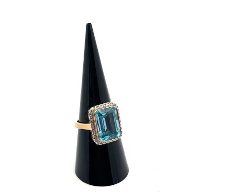 A topaz and diamond cluster dress ring, size M. The  emerald cut topaz approx 10mm x 14mm. Makers mark LSJ, London hallmarks.