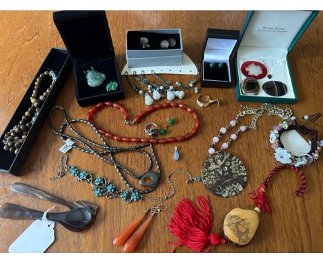 A number of pieces of hardstone and gem set jewellery, including a jade Buddha pendant, a tagua nut necklace, a pair of gold 