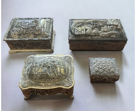 Four white metal trinket boxes with embossed decoration. Some of the hinges are in need repair - please see photos for condit