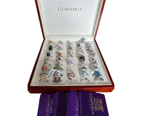 A polished wooden Gemporia ring box containing 41 sterling silver and gem set rings, many with their Gemporia tags still atta