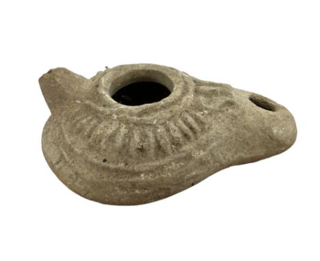 Roman, Terracotta pottery Oil lamp, 3rd – 4th Century A.D. Convex body with two openings and a miniature handle. Length 9cm.