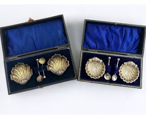 Two sets of cased scallop shell salts. A sterling silver set with scallop shell shaped spoons, by J &amp; R Griffin, Chester 