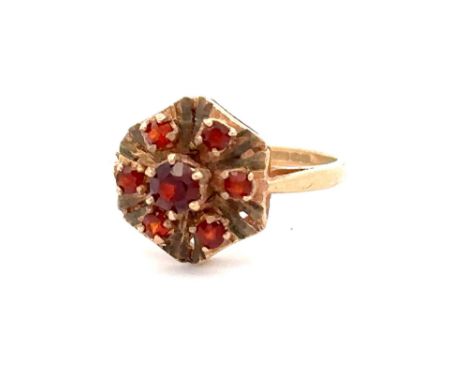 A 9ct gold and garnet cluster ring with Birmingham hallmarks. Size J. Weight 2.03g. Please see the buyer's terms and conditio