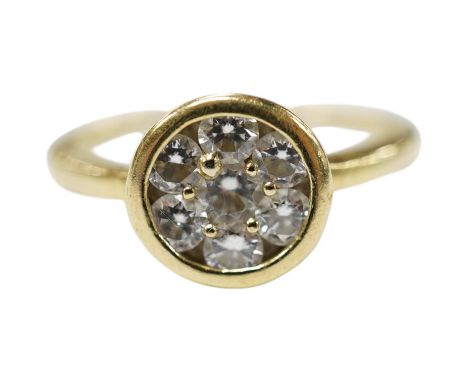 A yellow metal and seven stone diamond cluster set circular ring, size N/O, gross weight 3.4 grams. Condition - fair to good