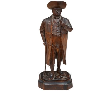 A 19th century Black Forest figure of a gentleman smoking a pipe, hinged at the waist to hold tobacco?, 36.5cm high. Conditio