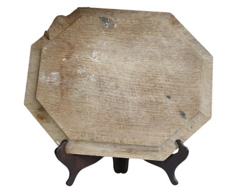 A Mouseman carved oak octagonal bread board, 30cm wide x 25cm deep. Condition - faded and scored