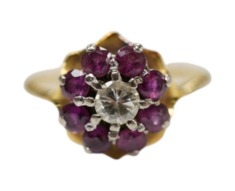 An 18ct, ruby and diamond set circular cluster ring, size O, gross weight 3 grams. Condition - fair