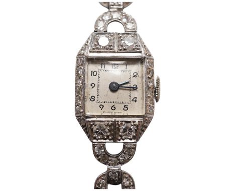 A lady's 1950's white metal and diamond cluster set manual wind cocktail watch, on a 9ct white gold bracelet, overall length 
