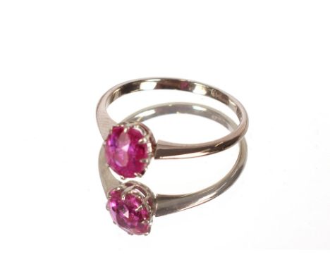 An Platinum ring set ruby coloured stone.