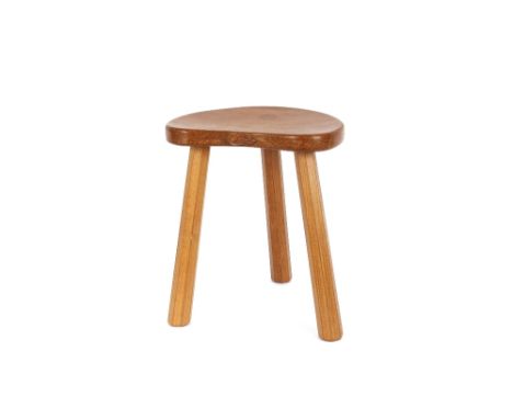 A Mouseman oak stool,&nbsp;of kidney shape raised on chamfered tapering supports, 36cm high x 30cm wide overall
