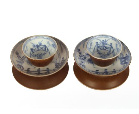 A pair of Chinese tea bowls and saucers,&nbsp;with Buddhist chicken decoration and brown under glaze