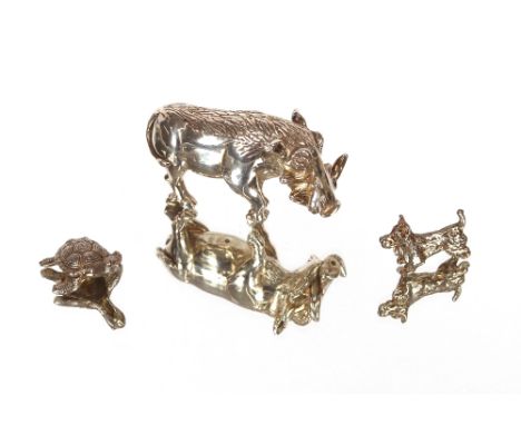 A finely modelled study of a wart hog,&nbsp;7.5cm long; a white metal model of a turtle; and another of a "Scottie" dog (3)