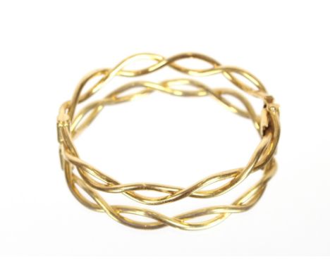 An 18ct gold snap bangle,&nbsp;of entwined design, approx. 17gms