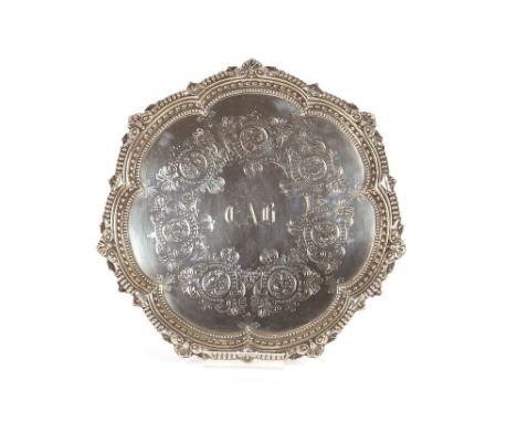 A late Victorian silver card tray, having shaped beaded and shell border, foliate engraved reserve, initialled C.A.B., makers