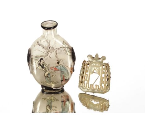 A Chinese&nbsp;snuff&nbsp;bottle,&nbsp;decorated with figures in an exotic garden (stopper missing); and a jade white metal m