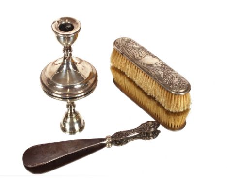 A silver mounted Art Nouveau design brush,&nbsp;London 1901; a silver handle shoe horn; and a dwarf silver candlestick&nbsp; 