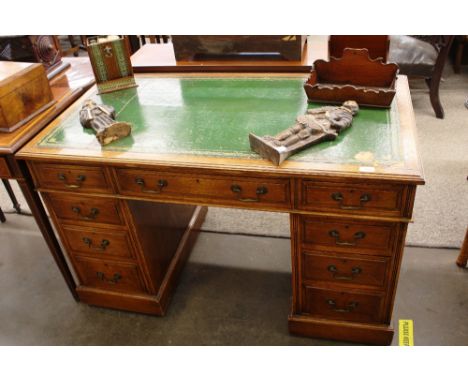 An Edwardian light oak pedestal desk,&nbsp;leather inset writing surface above three frieze drawers with six drawers to the p