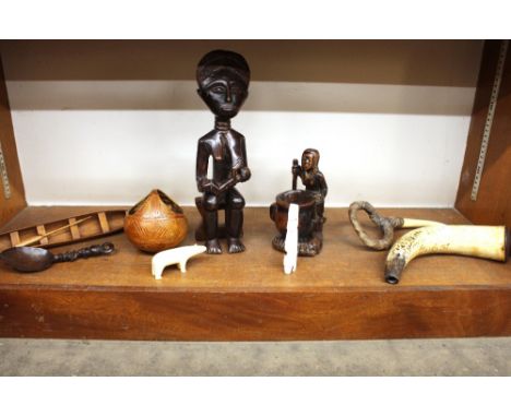 A collection of various miscellaneous wooden items,&nbsp;including native figure, model of a canoe, coconut vessel, various e