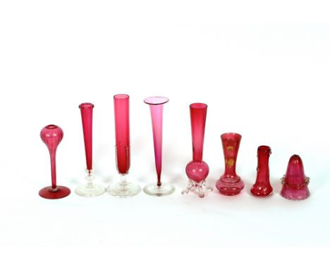 A collection of eight various cranberry and clear glass posy vases,&nbsp;including one with gilt enamel floral decoration (8)