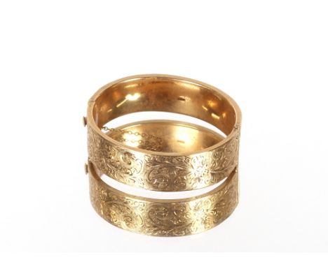 A 9ct gold snap bangle,&nbsp;with foliate engraved decoration, 26gms