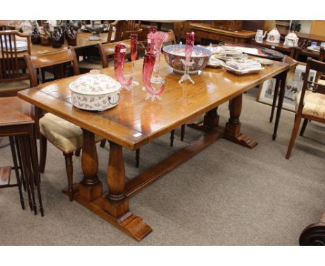 A good quality light oak refectory dining, table raised on turned baluster supports and block feet, 92cm x 198cm