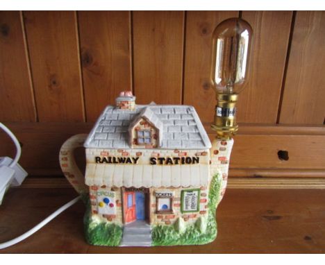 A novelty railway station teapot lamp
