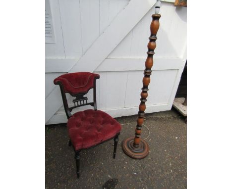 Upholstered mahogany chair and turned wooden floor lamp 