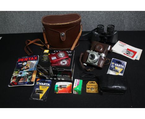 A group of three cameras including Pentax, Voigtländer and a Nikon digital camera with accessories, together with a pair of c