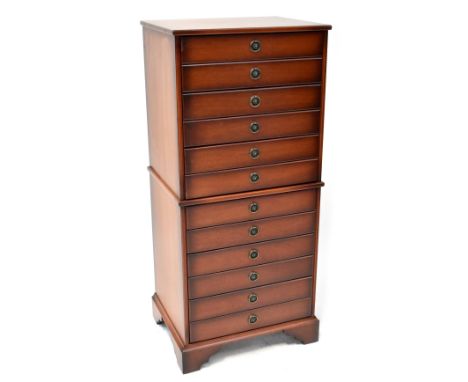 A reproduction floor standing CD cabinet comprising six fitted drawers with ring drop handles, on bracket feet, 105 x 52 x 40