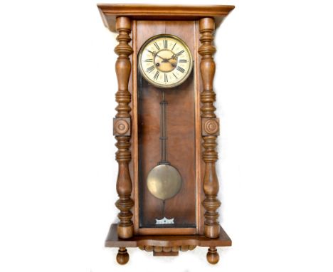 A Victorian walnut spring-driven Vienna wall clock, the dial set with Roman numerals, case with baluster and turned pilasters