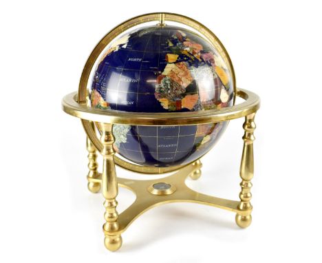 A hardstone globe on a brass-effect stand, united by a cross-stretcher mounted with a compass, height 46cm.