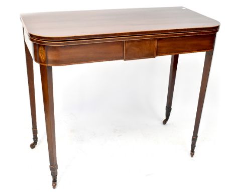 A 19th century mahogany tea table, fold-over top with stringing above a frieze with inlaid oak leaf and acorn motif, on squar