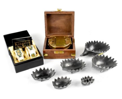 A pair of Kingsley floral enamel napkin rings in presentation box, a reproduction maritime brass compass in wooden box and an