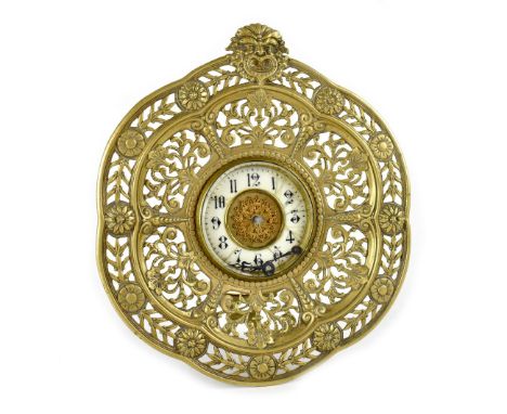 An early 20th century table clock with barrel movement, enamelled chapter rings set with Arabic increments around gold colour