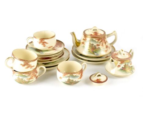 A Japanese Satsuma part tea service comprising teapot, four plates, five saucers, three cups and covered milk jug with red an